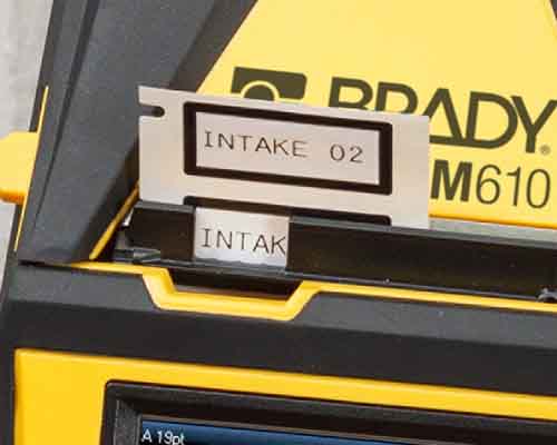 Nyligt udskrevne labels på vej ud af M610-printeren. 